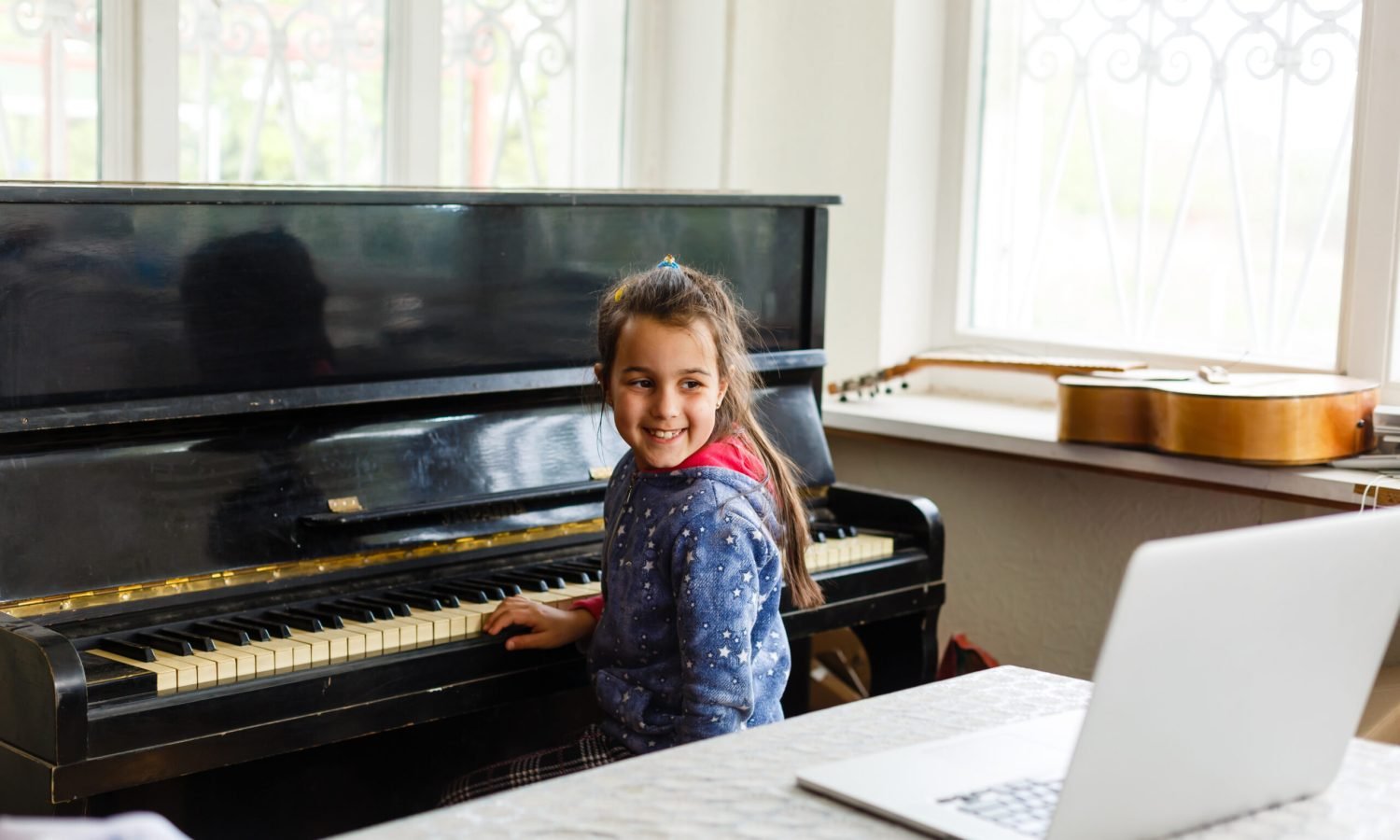 smiling-girl-plays-piano-with-laptop-nearby-2026-01-09-13-42-13-utc